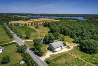 drone view of Wainer Farm in Dartmouth, with Buzzards Bay in the background