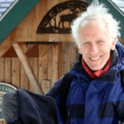 andy falender in winter jacket in front of a barn